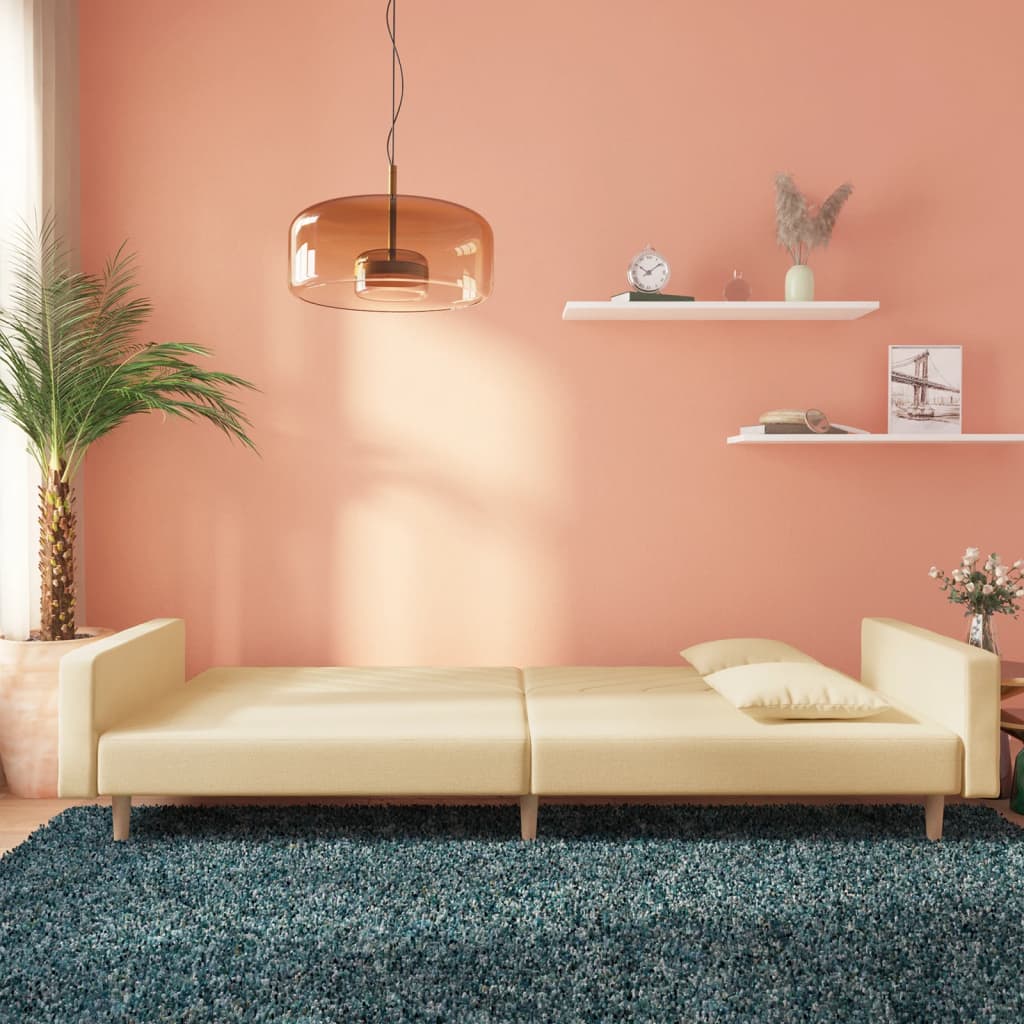 2-seater sofa bed with two cushions in cream-colored fabric
