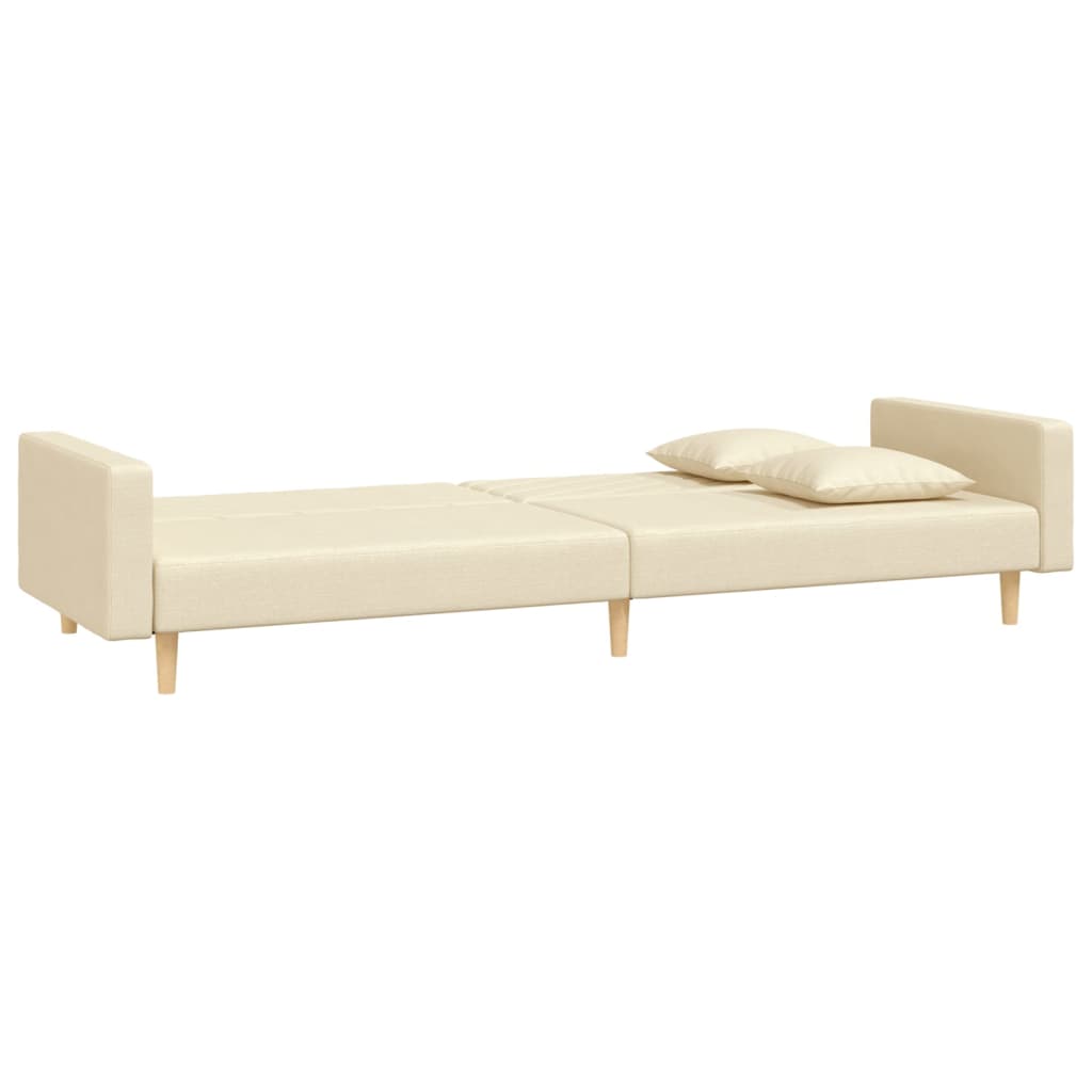 2-seater sofa bed with two cushions in cream-colored fabric
