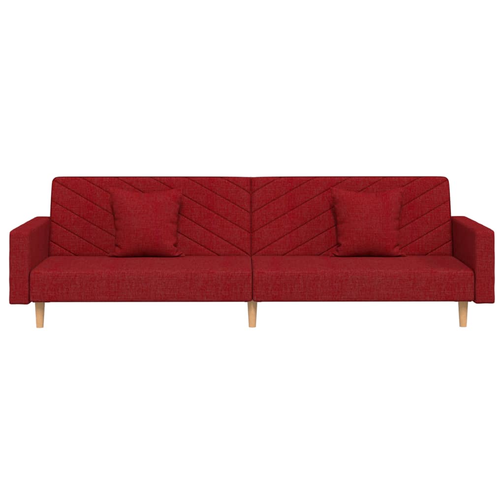 2-seater sofa bed with two cushions in red fabric