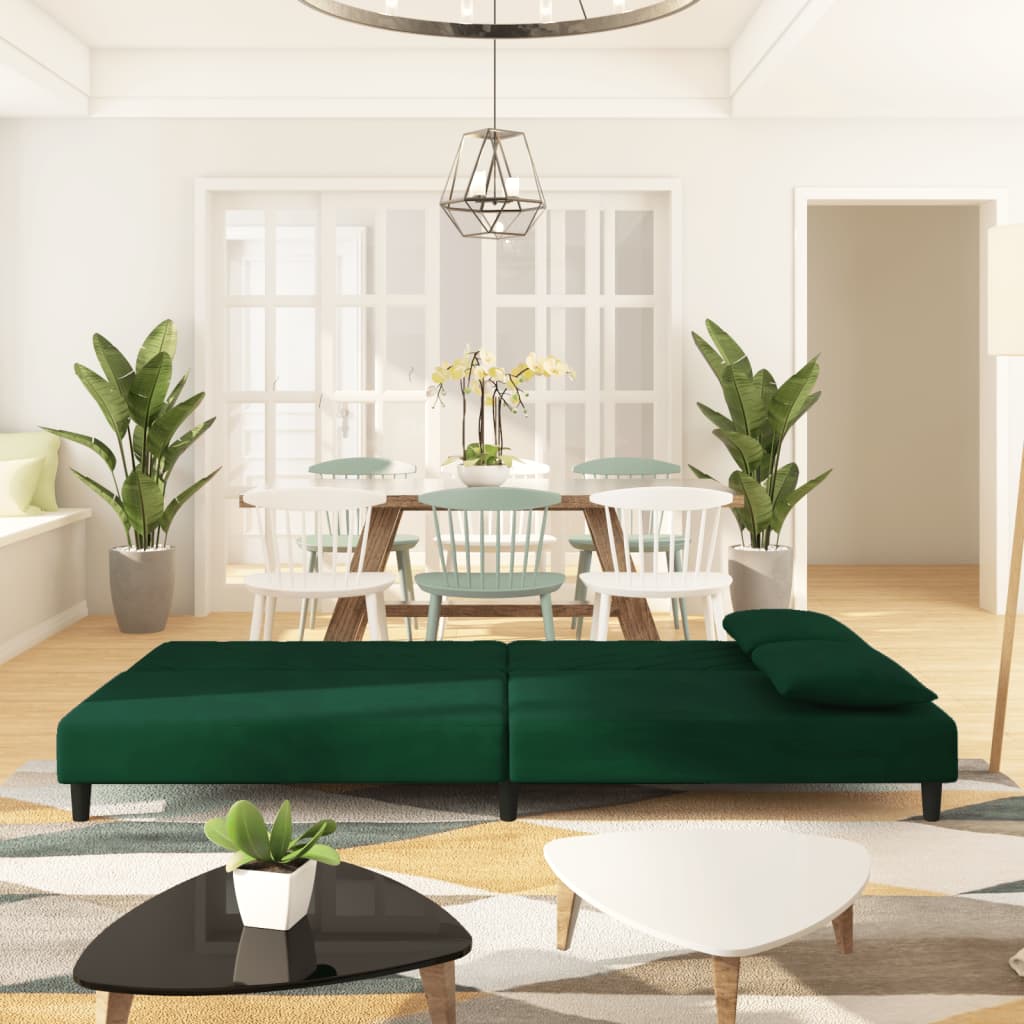 2-seater sofa bed with two dark green velvet cushions