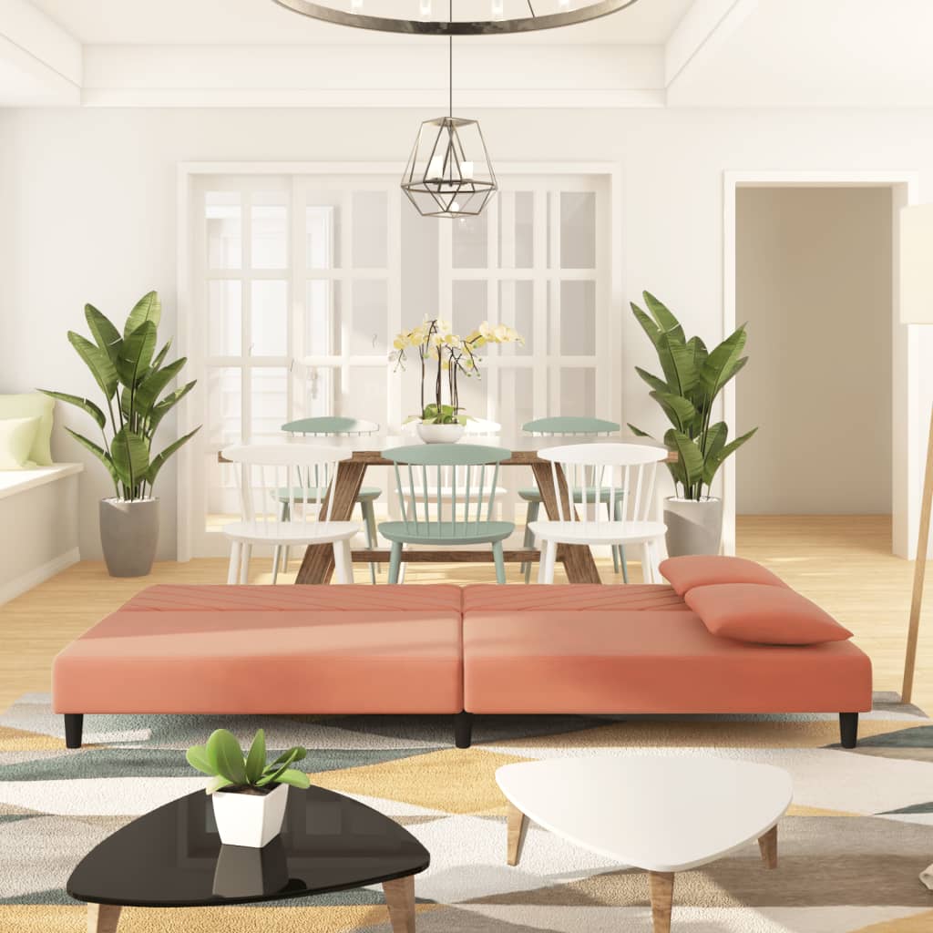 2-seater sofa bed with two pink velvet cushions