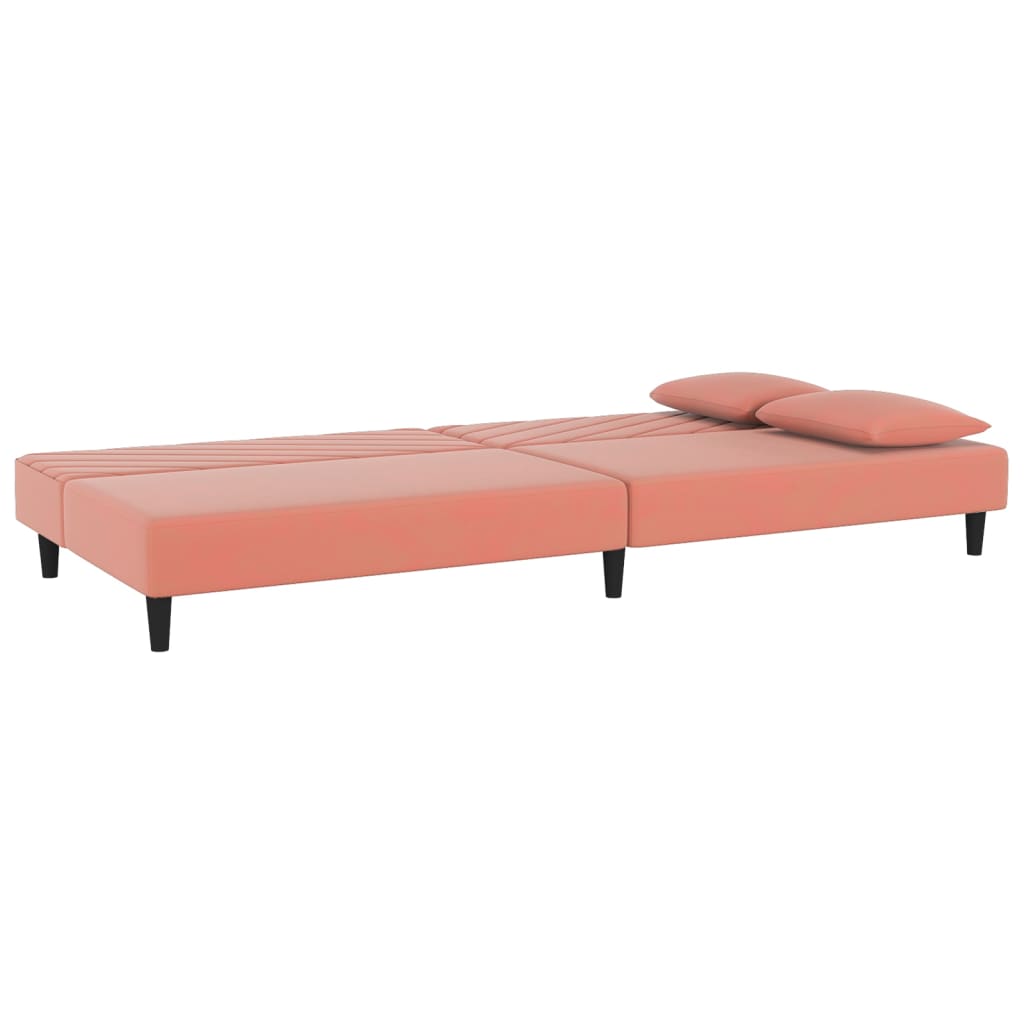 2-seater sofa bed with two pink velvet cushions