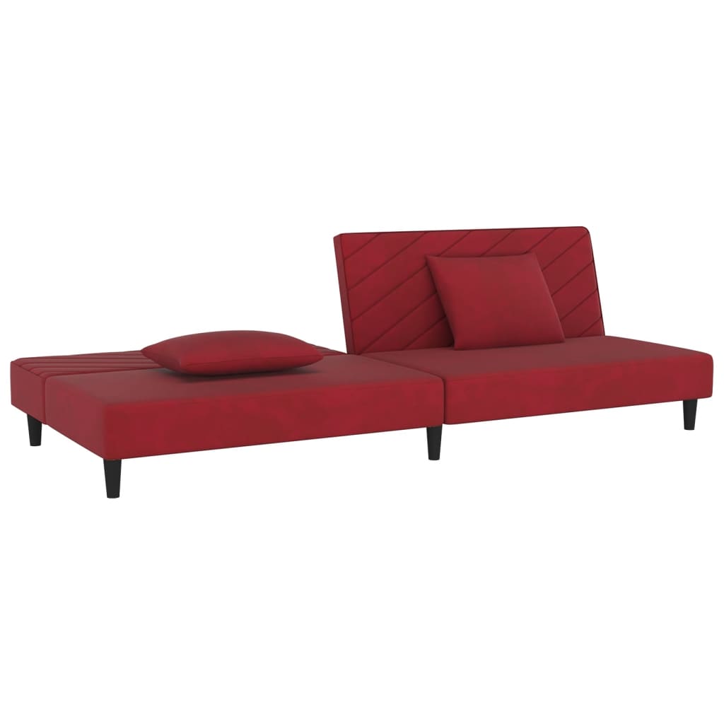 2-seater sofa bed with two red velvet cushions