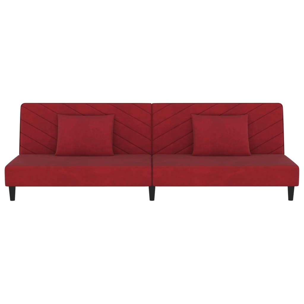 2-seater sofa bed with two red velvet cushions