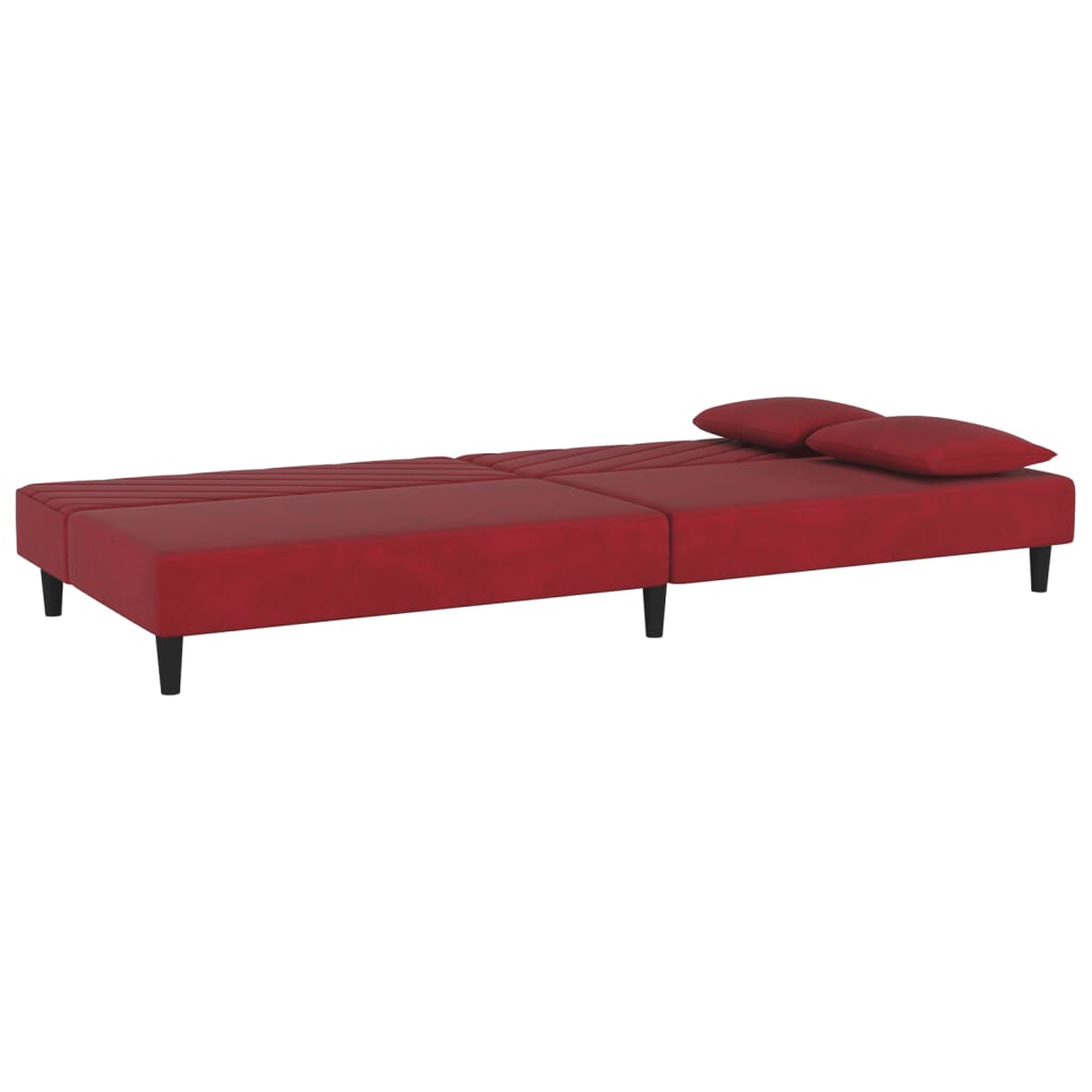 2-seater sofa bed with two red velvet cushions