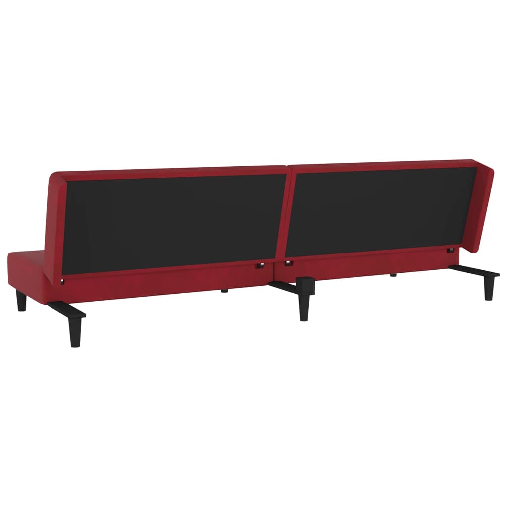 2-seater sofa bed with two red velvet cushions