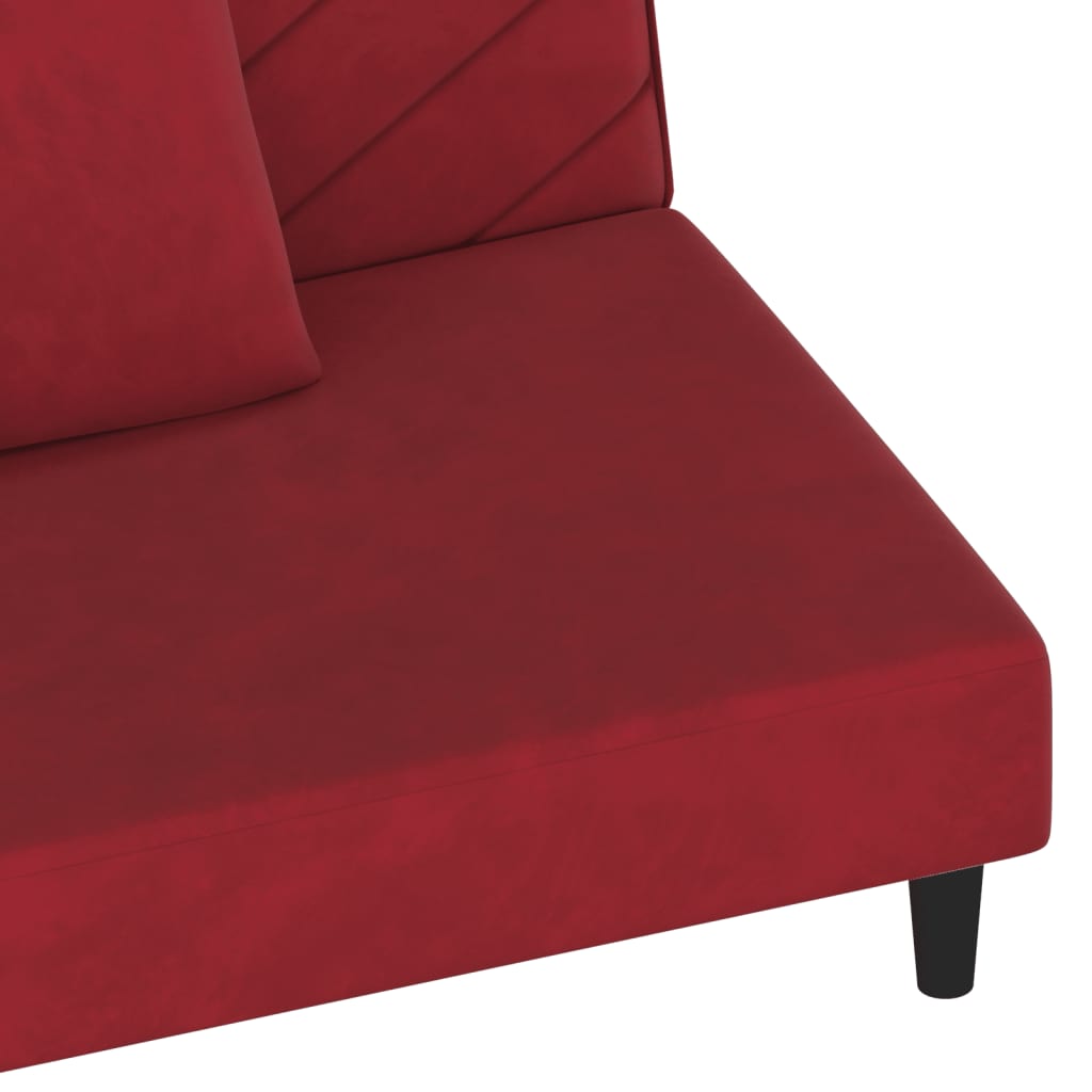 2-seater sofa bed with two red velvet cushions