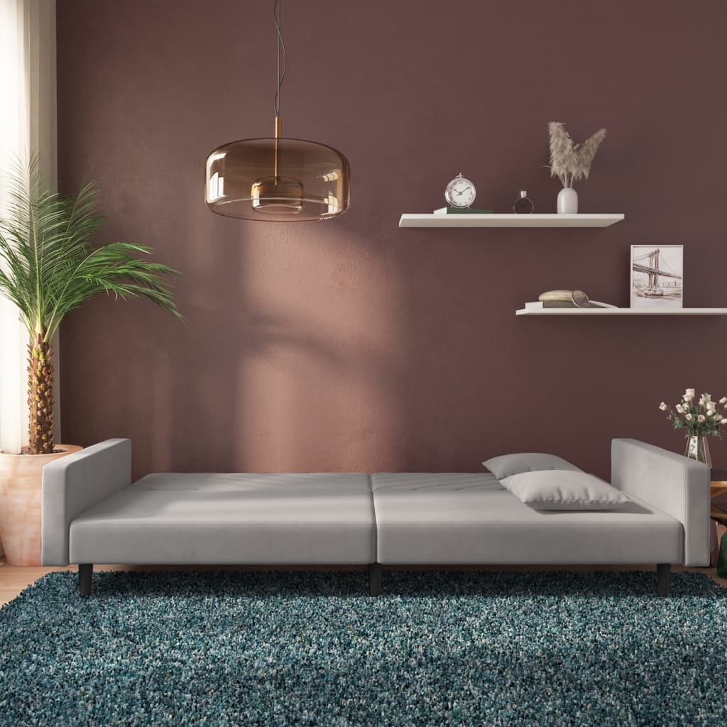 2-seater sofa bed with two light grey velvet cushions
