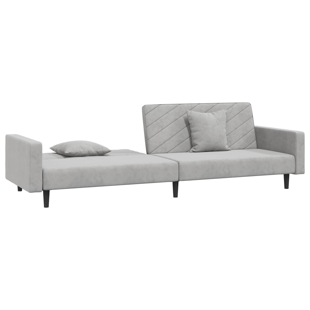 2-seater sofa bed with two light grey velvet cushions