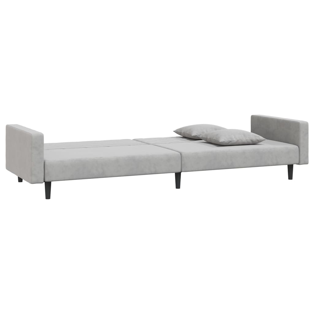 2-seater sofa bed with two light grey velvet cushions