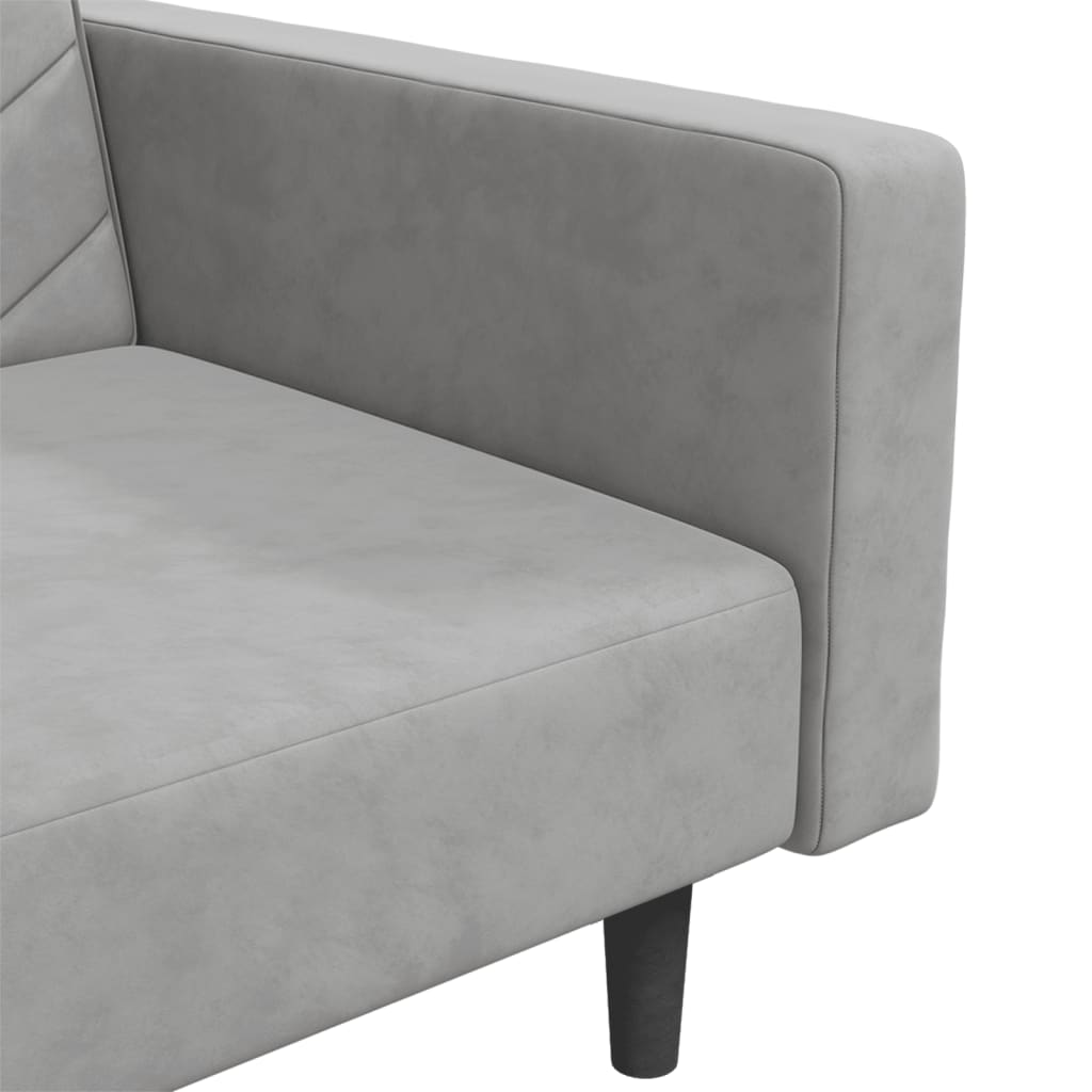 2-seater sofa bed with two light grey velvet cushions