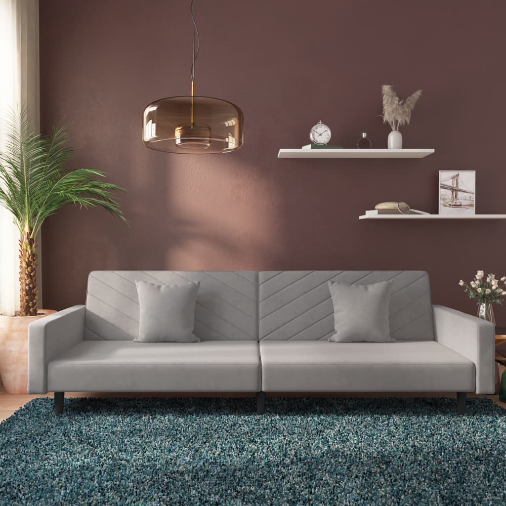 2-seater sofa bed with two light grey velvet cushions