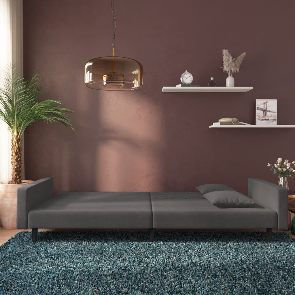 2-seater sofa bed with two dark grey velvet cushions