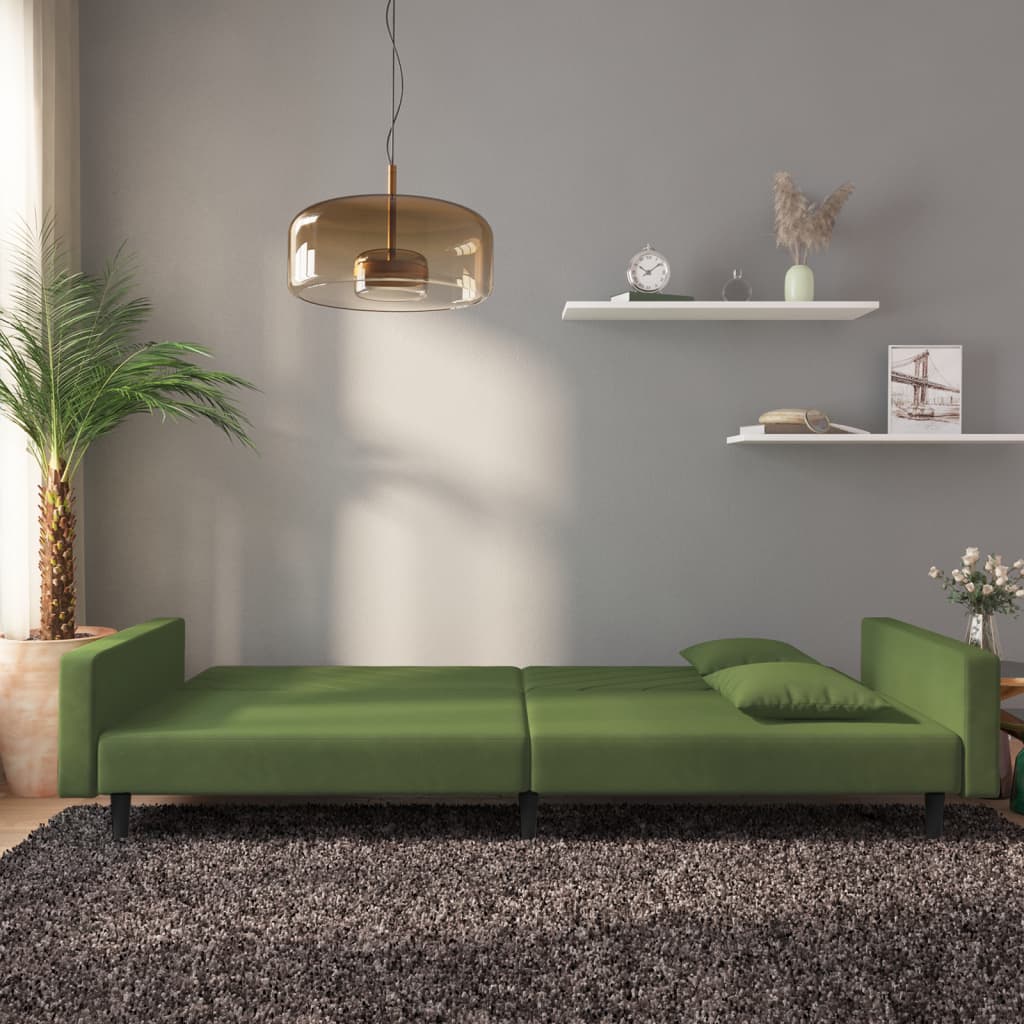 2-seater sofa bed with two dark green velvet cushions