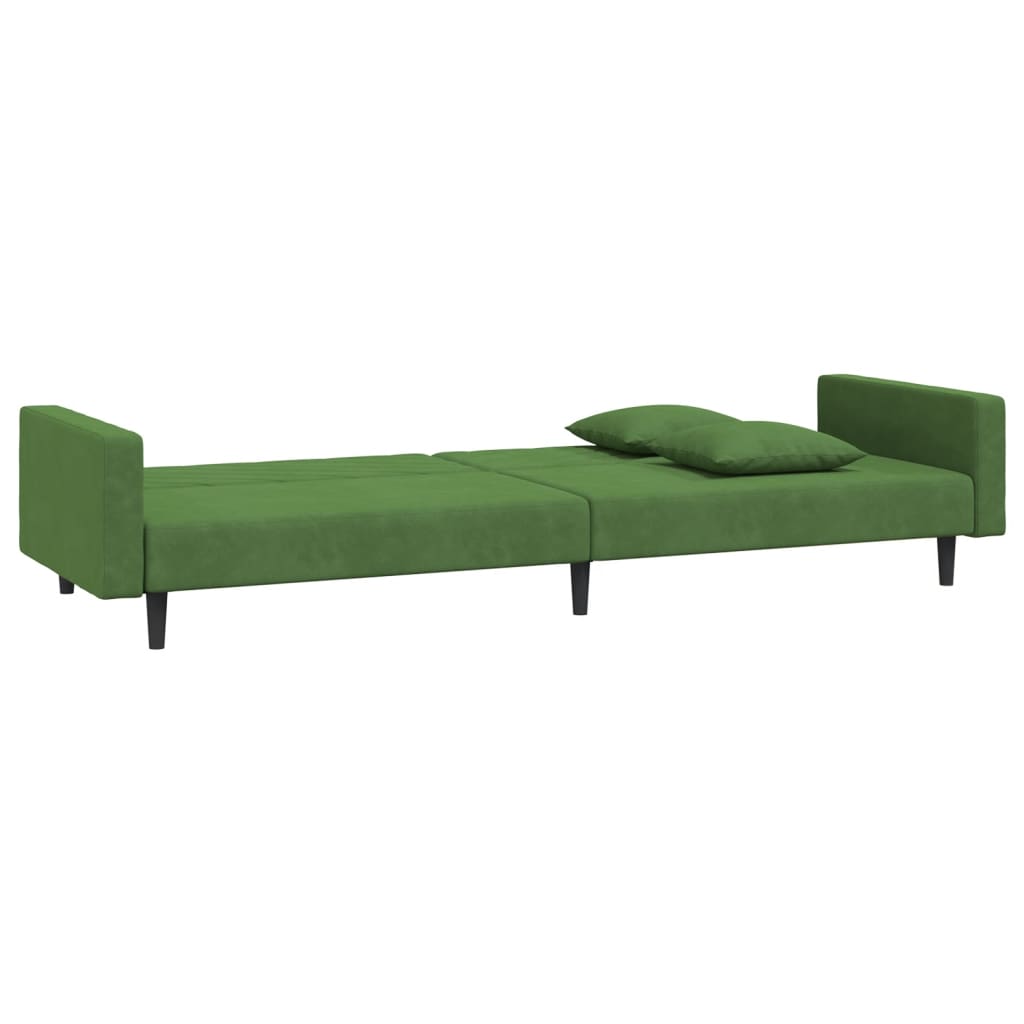 2-seater sofa bed with two dark green velvet cushions