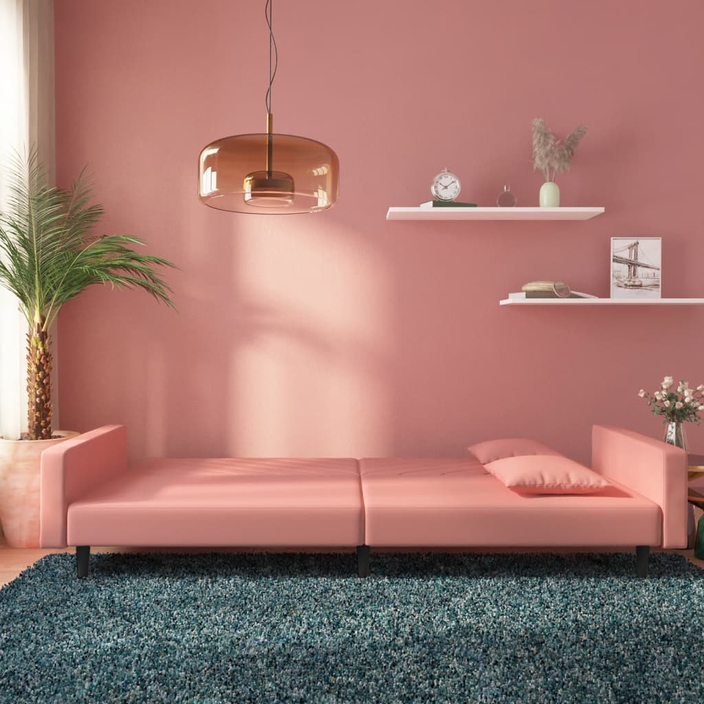 2-seater sofa bed with two pink velvet cushions