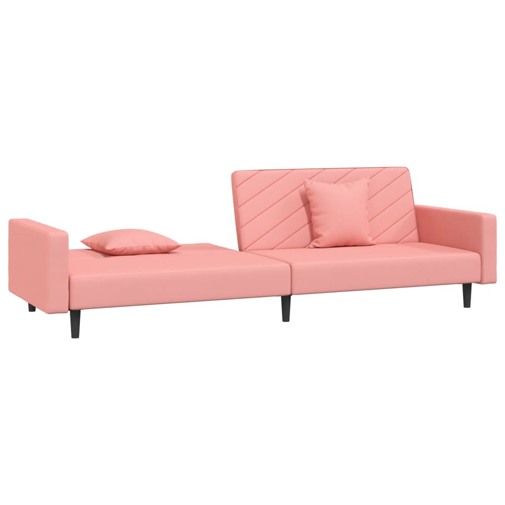 2-seater sofa bed with two pink velvet cushions