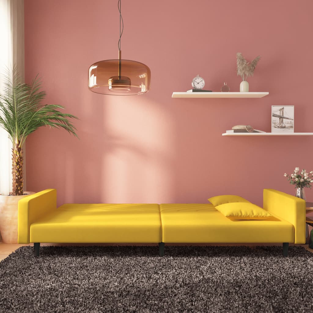 2-seater sofa bed with two yellow velvet cushions