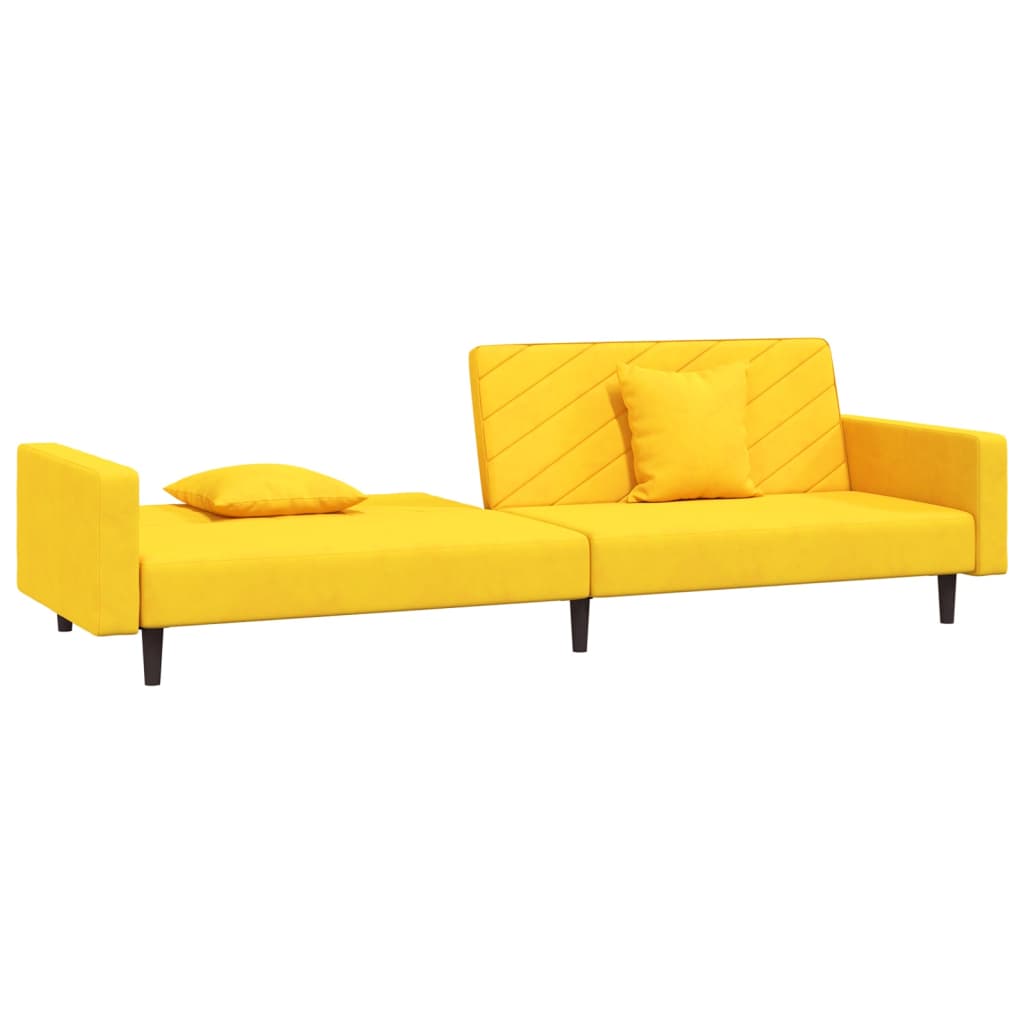 2-seater sofa bed with two yellow velvet cushions