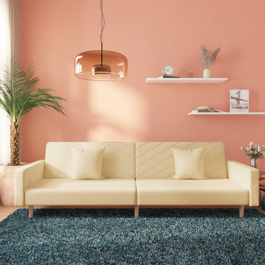 2-seater sofa bed with two cushions in cream-colored fabric
