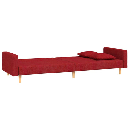 2-seater sofa bed with two cushions in red fabric