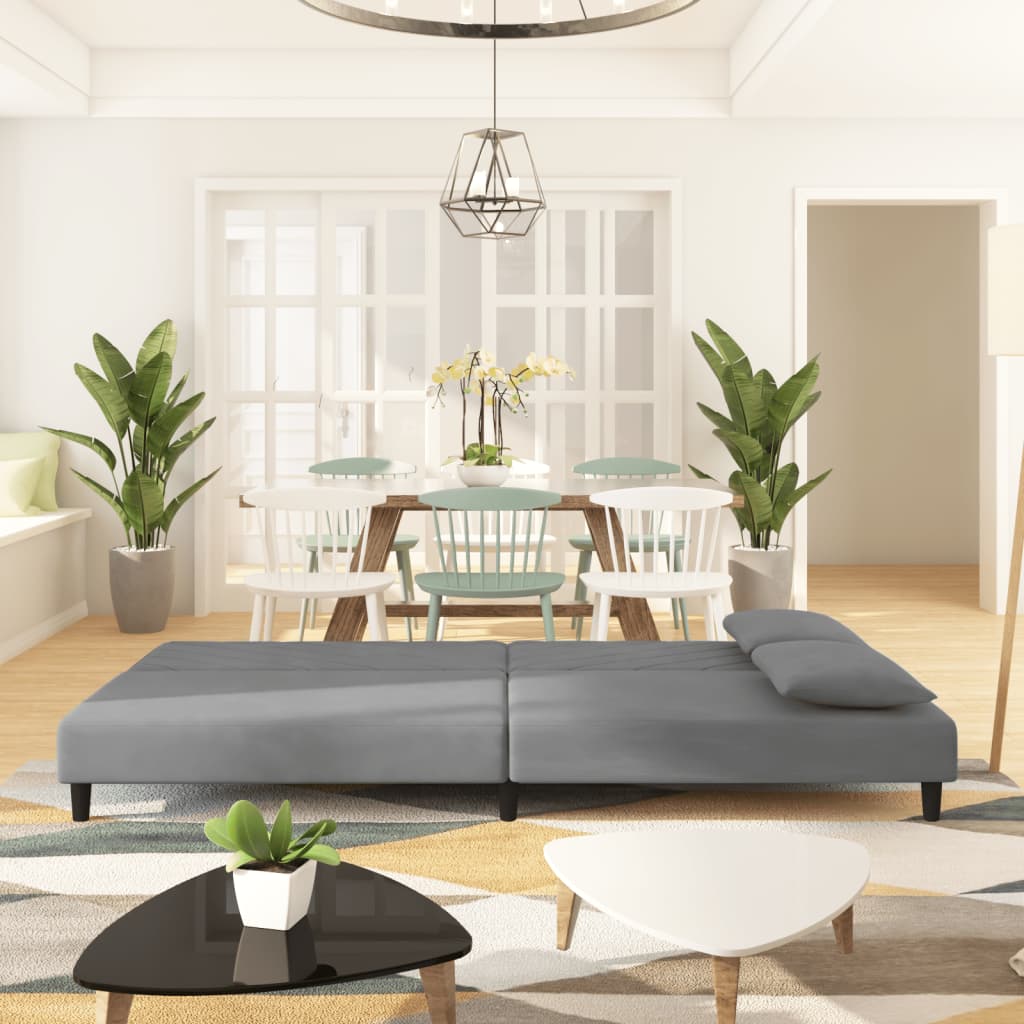 2-seater sofa bed with two light grey velvet cushions