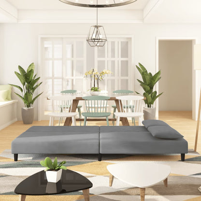 2-seater sofa bed with two light grey velvet cushions