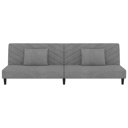 2-seater sofa bed with two light grey velvet cushions
