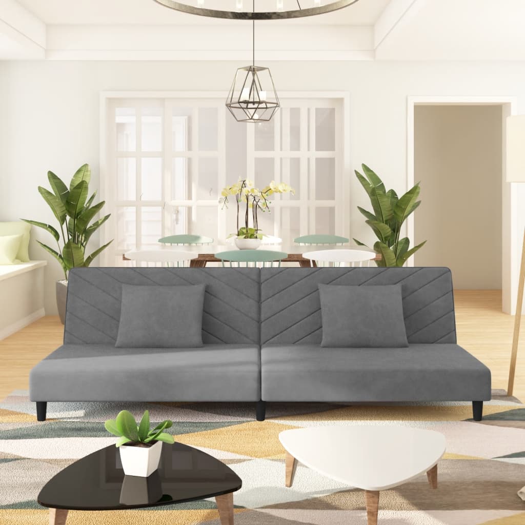 2-seater sofa bed with two light grey velvet cushions
