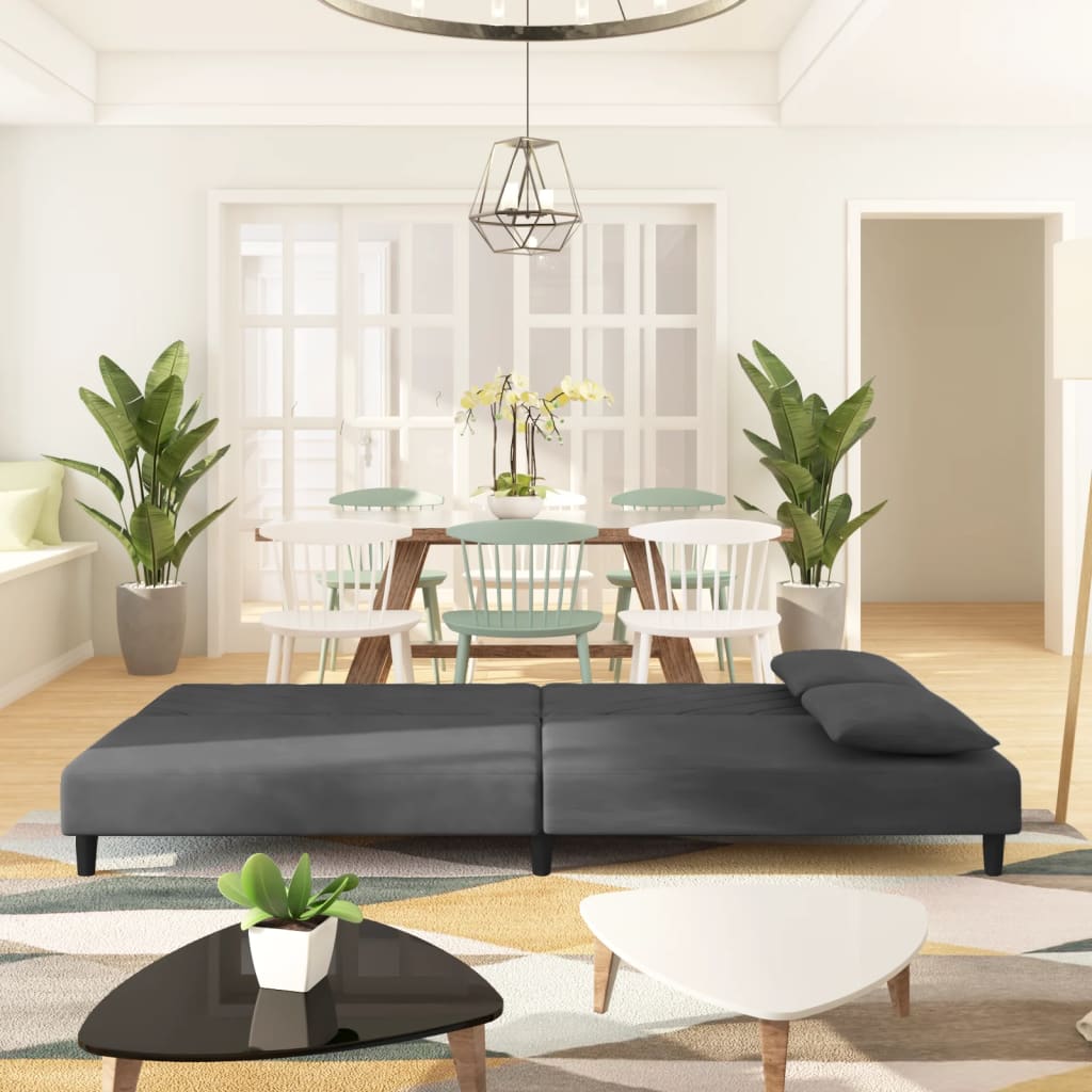 2-seater sofa bed with two dark grey velvet cushions