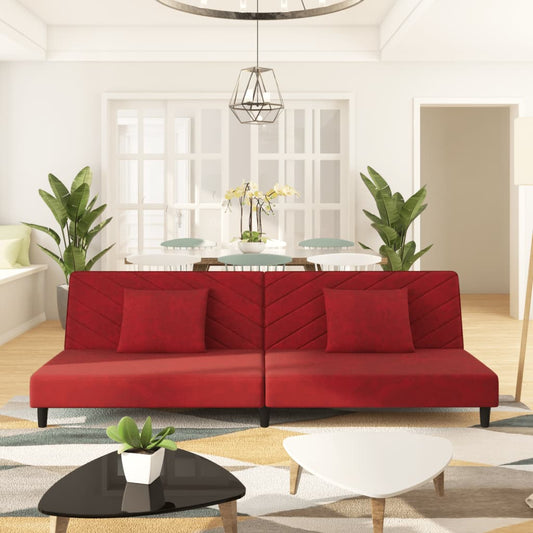 2-seater sofa bed with two red velvet cushions
