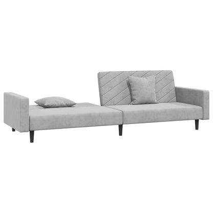 2-seater sofa bed with two light grey velvet cushions