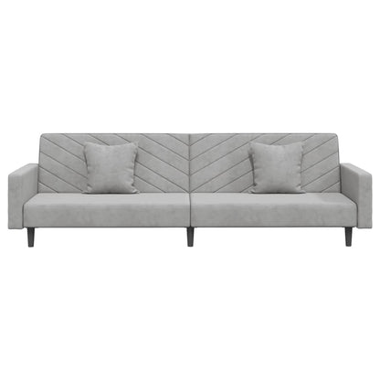 2-seater sofa bed with two light grey velvet cushions