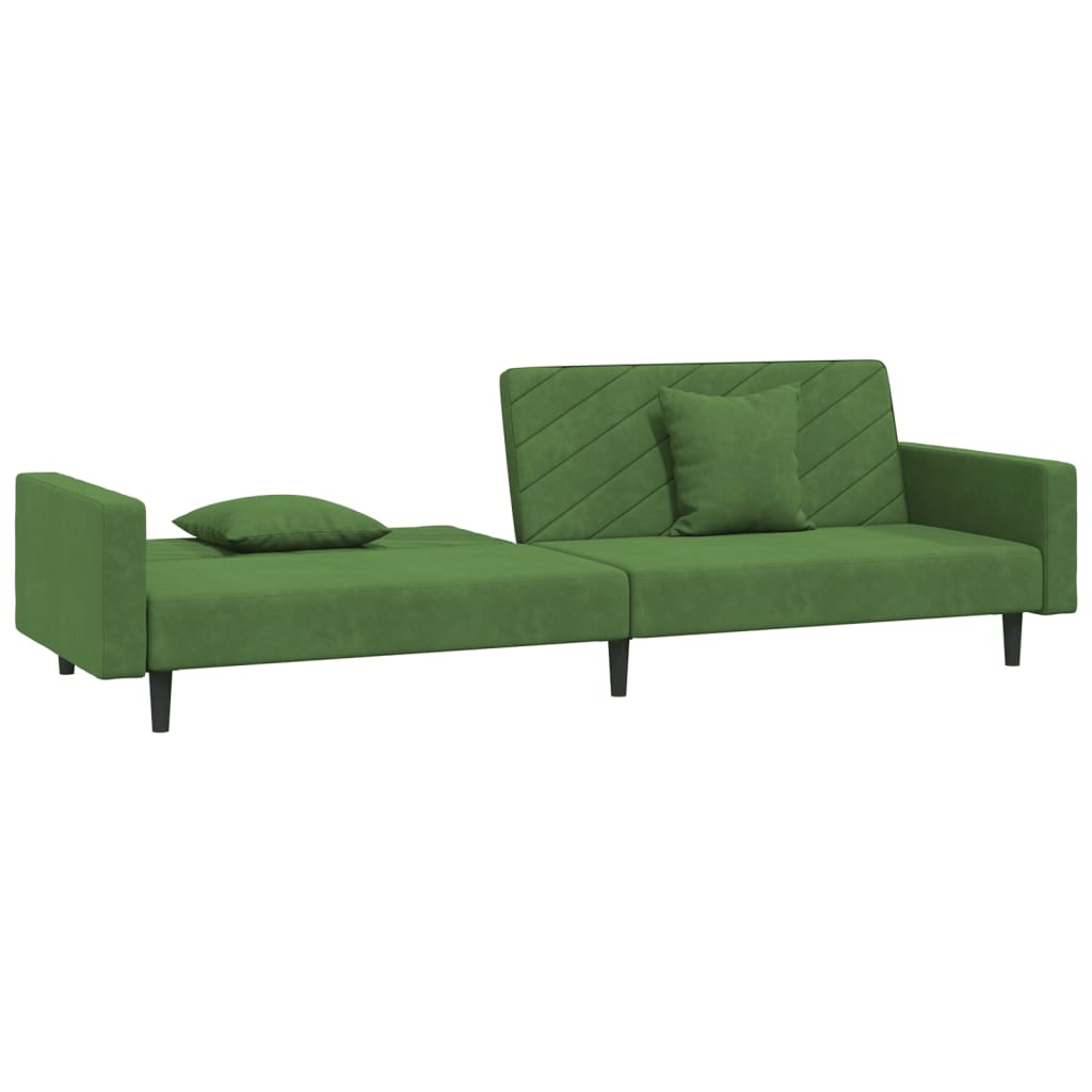 2-seater sofa bed with two dark green velvet cushions