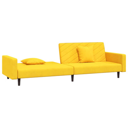 2-seater sofa bed with two yellow velvet cushions