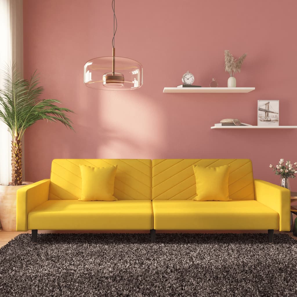 2-seater sofa bed with two yellow velvet cushions
